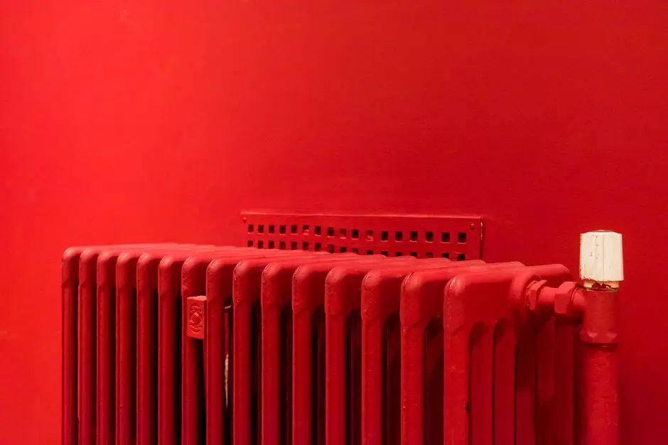 A vibrant red radiator against a matching wall captures minimalist and modern interior design.