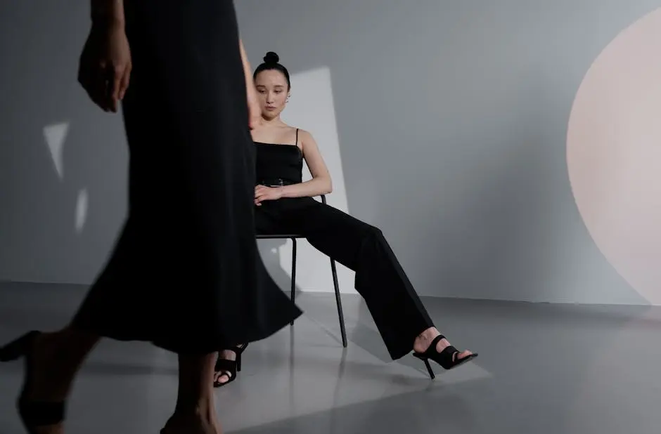 Chic and modern fashion photoshoot featuring a woman in black in a stylish studio setup.