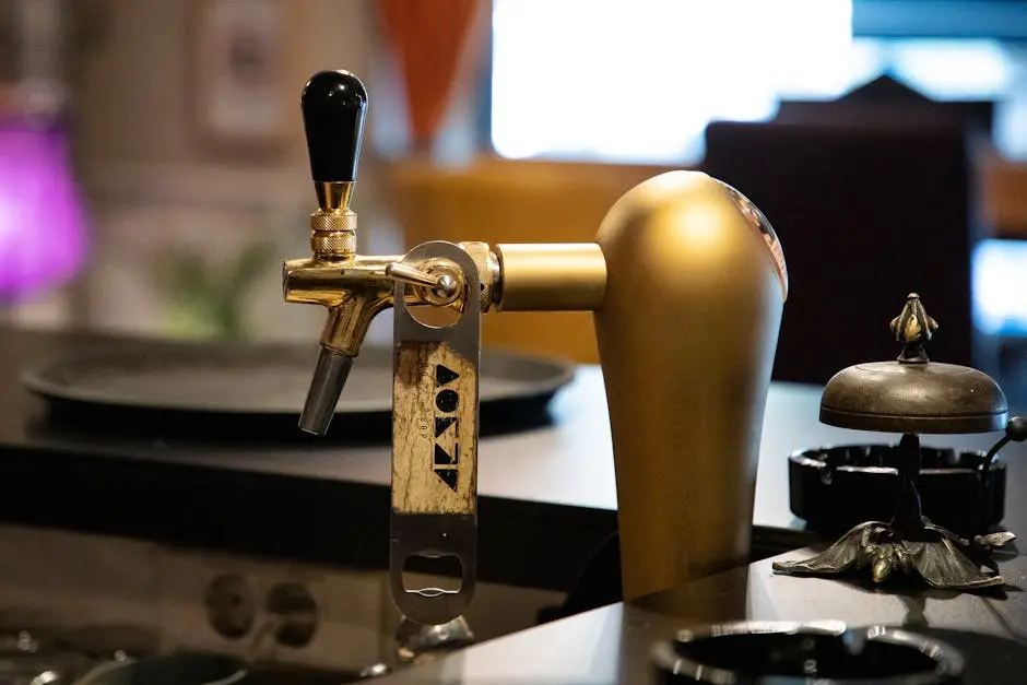 Close-up of a golden beer tap with vintage design in a bar setting, adding a classic touch.