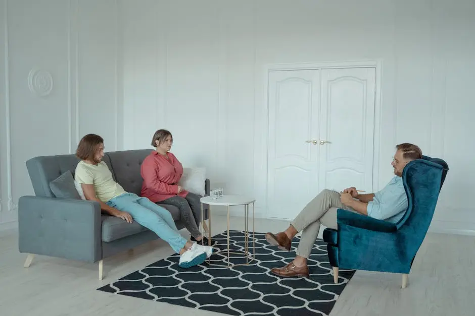 A married couple consulting with a therapist during a session in a modern office space.