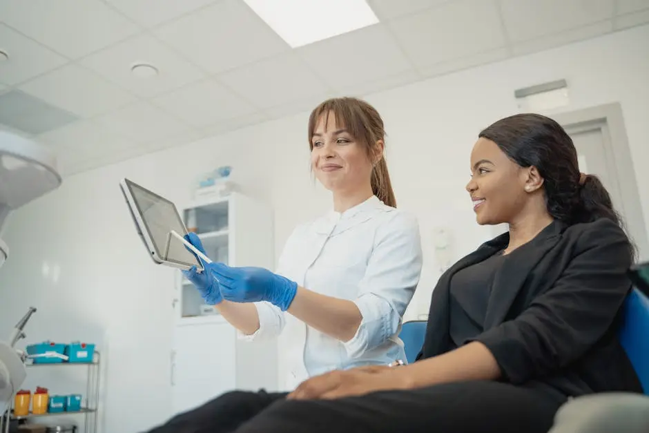 Dentist and patient discussing treatment plan using a tablet in a modern clinic setting.