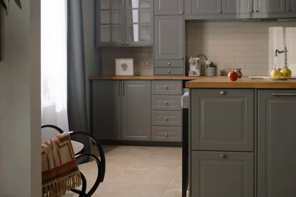 Stylish gray kitchen interior with wooden countertops, natural lighting, and modern design elements.