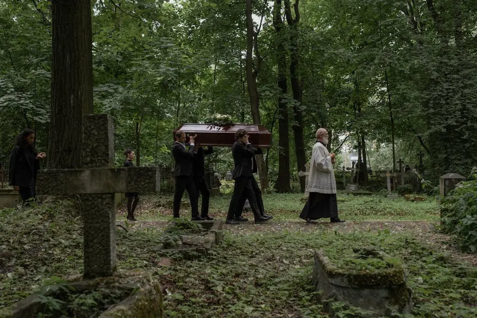 A solemn funeral procession with a priest and pallbearers carrying a coffin through a lush cemetery.