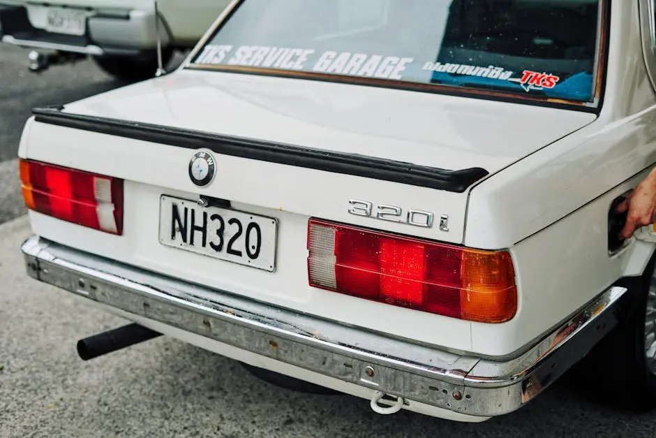 Rear view of a modified vintage BMW 320i car in Auckland, capturing its unique style.