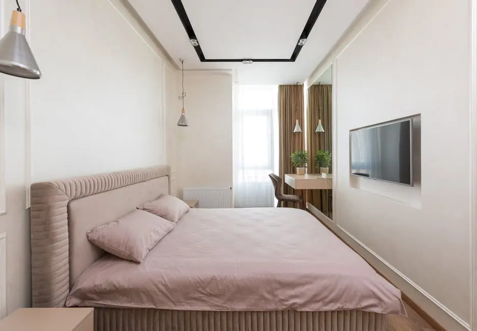 A serene and contemporary bedroom interior with pastel tones, featuring a stylish bed, decor, and natural light.