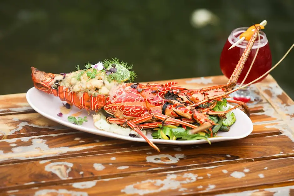 A gourmet lobster dish served with a refreshing cocktail, perfect for fine dining experiences in Bengaluru, India.