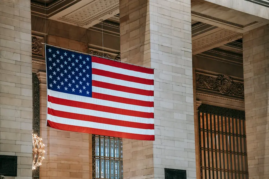 American flag hangs in a grand interior, symbolizing patriotism within an architectural landmark.