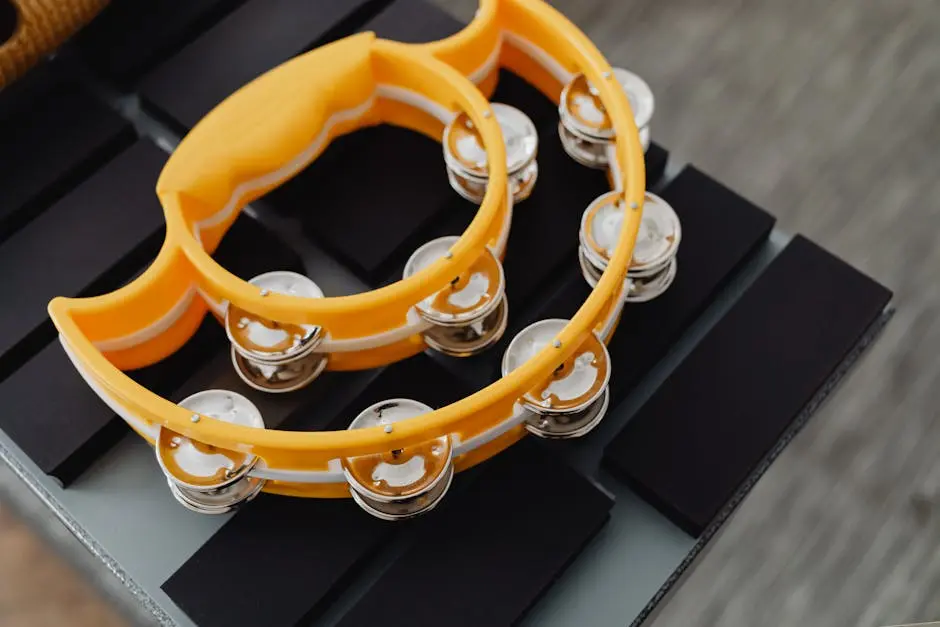 Bright yellow tambourine resting on a black keyboard. Perfect for music-related themes.