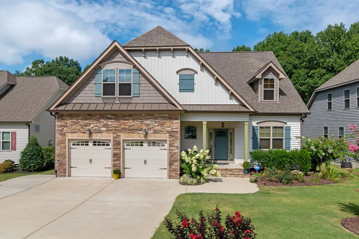 Charming suburban house with a double garage and landscaped yard.