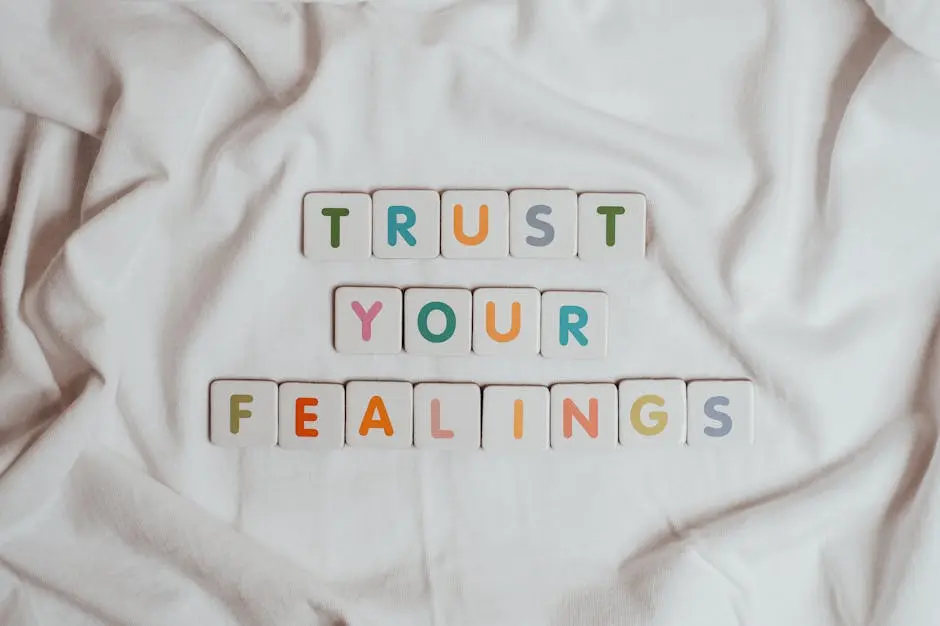 Colorful tiles spell out &lsquo;Trust your feelings&rsquo; on a fabric background.