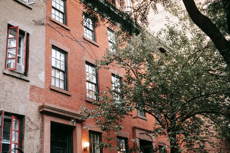 Elegant urban brick facade with windows and greenery, featuring a rustic charm.