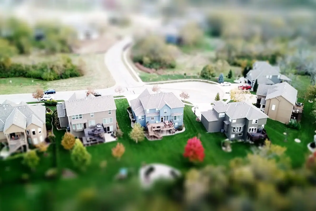 Aerial photo showcasing residential houses in a suburban neighborhood with lush greenery and streets.