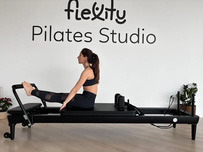 Adult woman performing Pilates exercise on reformer at Flexity Pilates Studio.