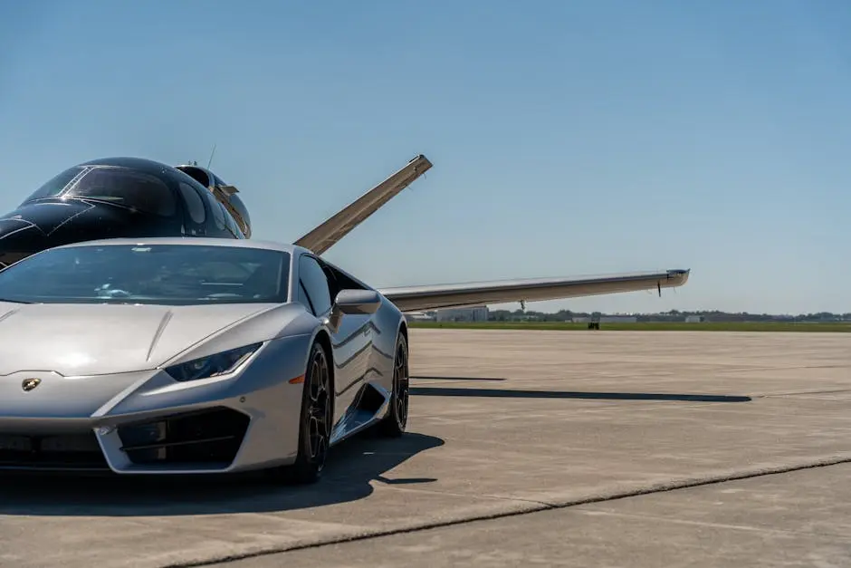 Sleek silver Lamborghini parked in front of a private jet on a clear day at an airport runway.