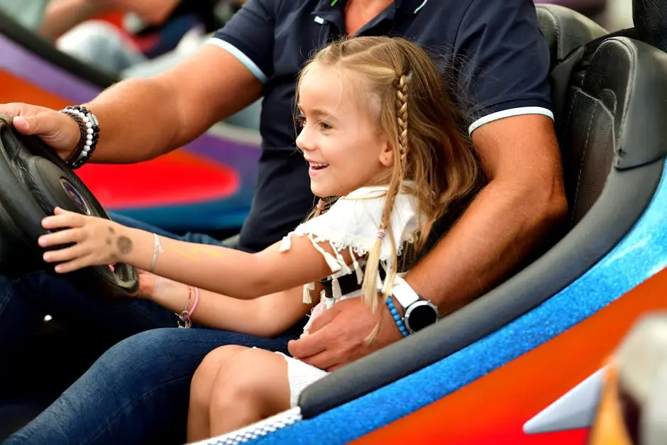 Father and daughter enjoying a fun bumper car ride, filled with smiles and laughter.