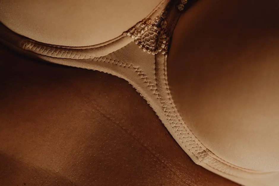 Intimate close-up of beige lingerie revealing skin texture and detail.