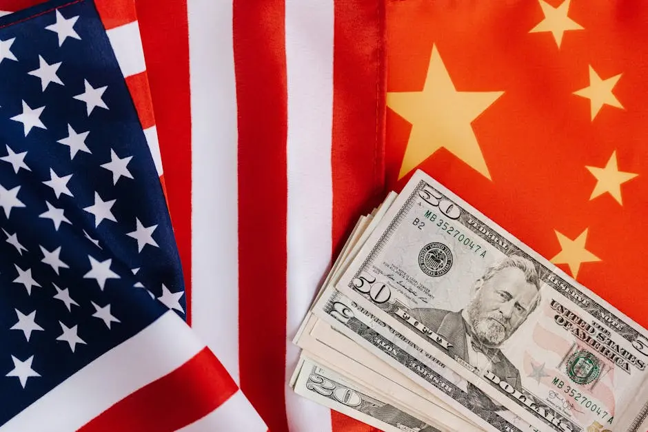 Close-up of US and China flags with US dollar bills, representing international trade and finance.