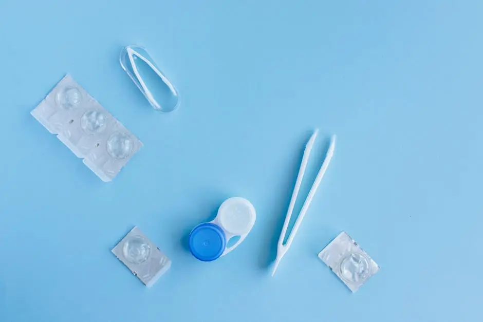 Flat lay of contact lens accessories including case and tweezers on a blue background.