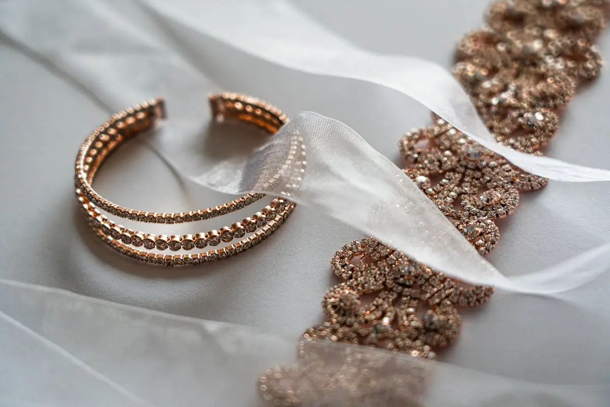 Close-up of luxurious rose gold bracelet and lace, ideal for brides.