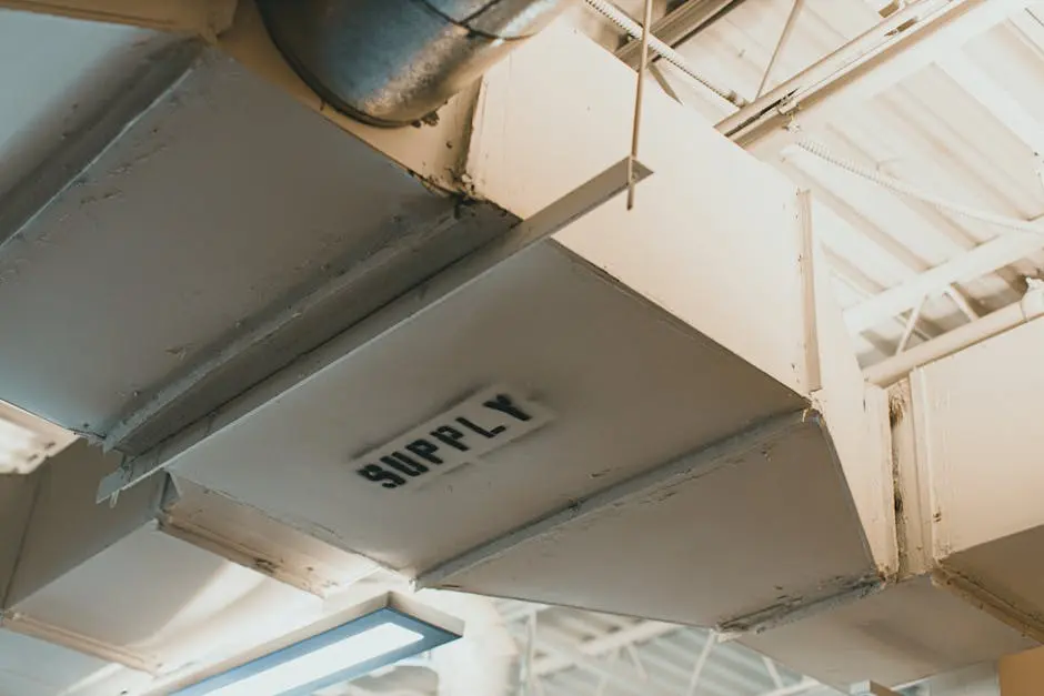 Close-up view of an air duct labeled ‘SUPPLY’ in an industrial setting.