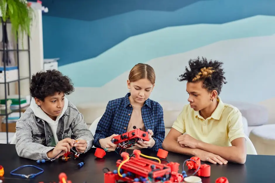 Three children collaborating on a robotics project at a table indoors, fostering STEM learning.