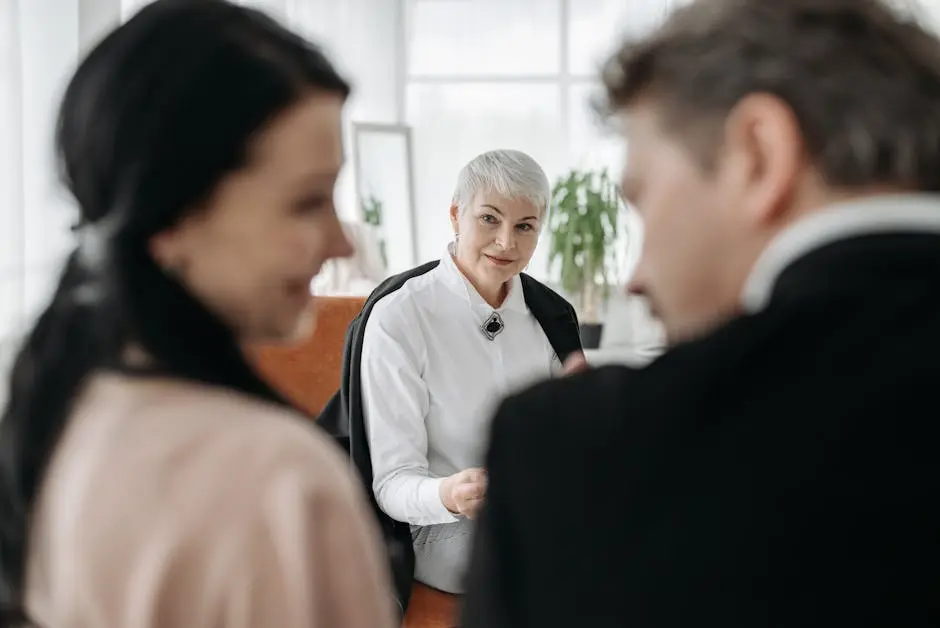 A professional consultation session with a couple and a social worker in a modern office environment.