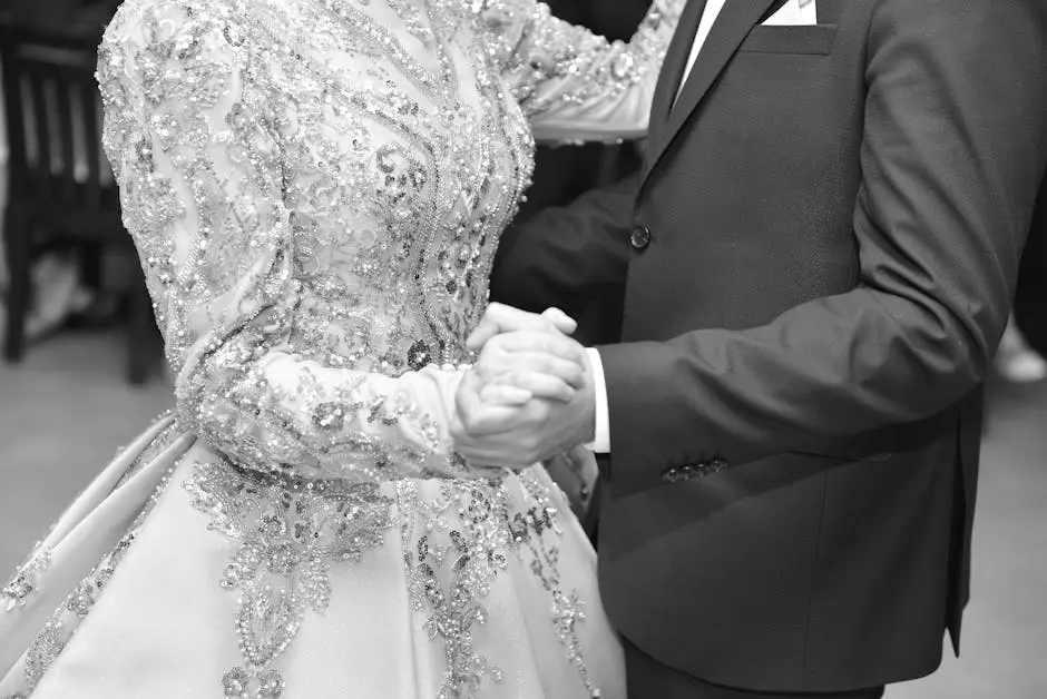 A couple elegantly dancing in a detailed wedding dress and tuxedo.