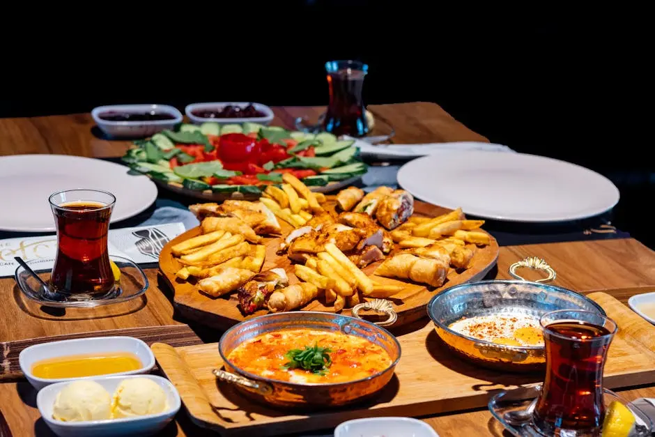 Appetizing spread of Mediterranean dishes with tea on a wooden table, perfect for a delightful meal.