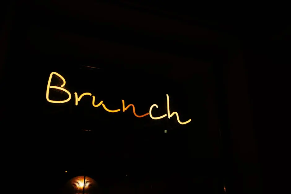 Bright neon sign displaying ‘Brunch’ against a dark background, creating a vibrant contrast.