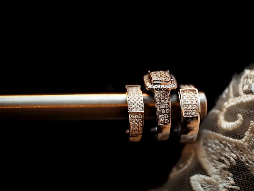Close-up of luxury diamond wedding rings elegantly arranged with delicate lace in the background.