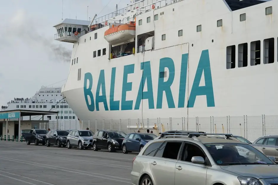 Balearia cruise ship docked at Valencia port with parked cars nearby.