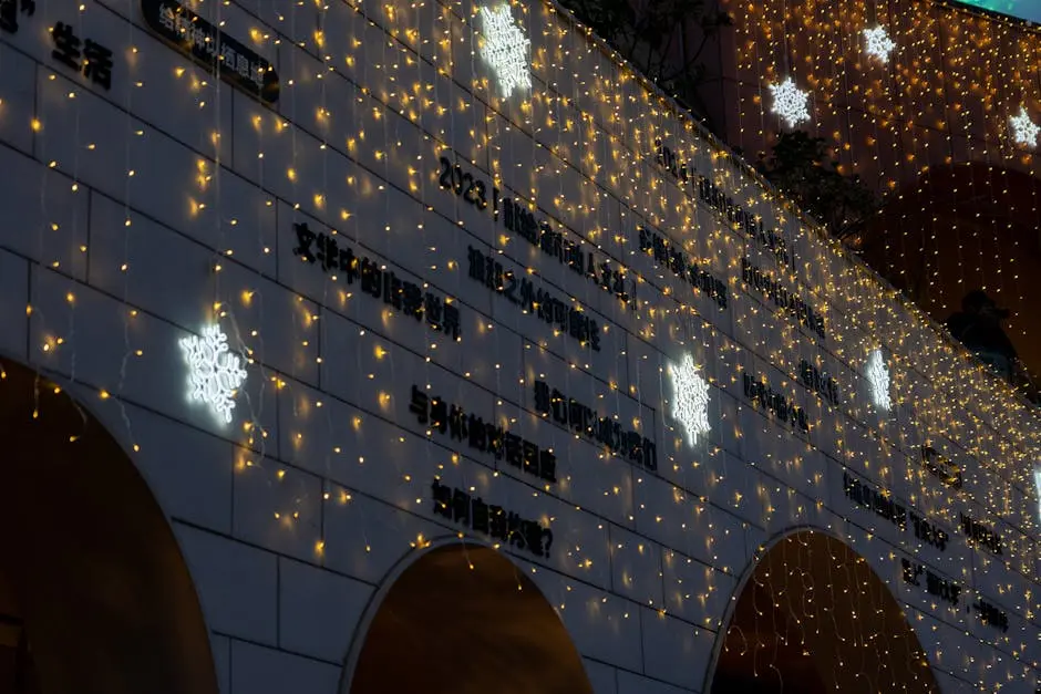 Building decorated with snowflake lights and strings of yellow fairy lights.