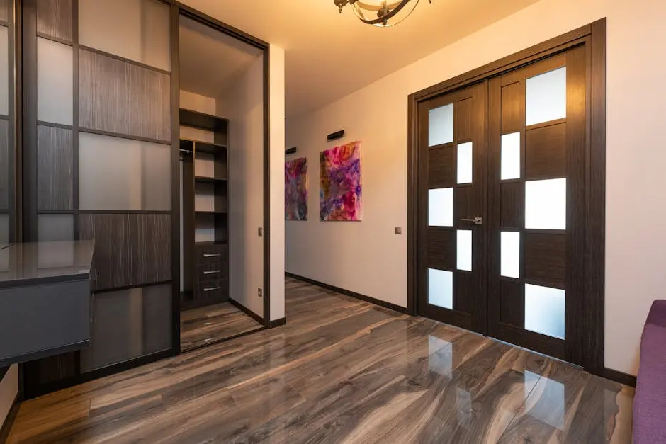 Spacious modern hallway featuring wooden doors, a sliding closet, and abstract art for a contemporary look.