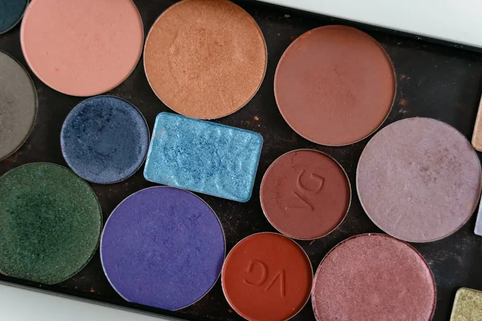 Close-up of a colorful eyeshadow palette showcasing various shades.