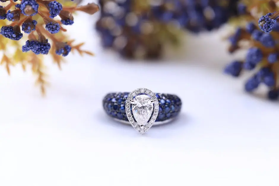 Close-up of a dazzling diamond and sapphire ring surrounded by floral elements.