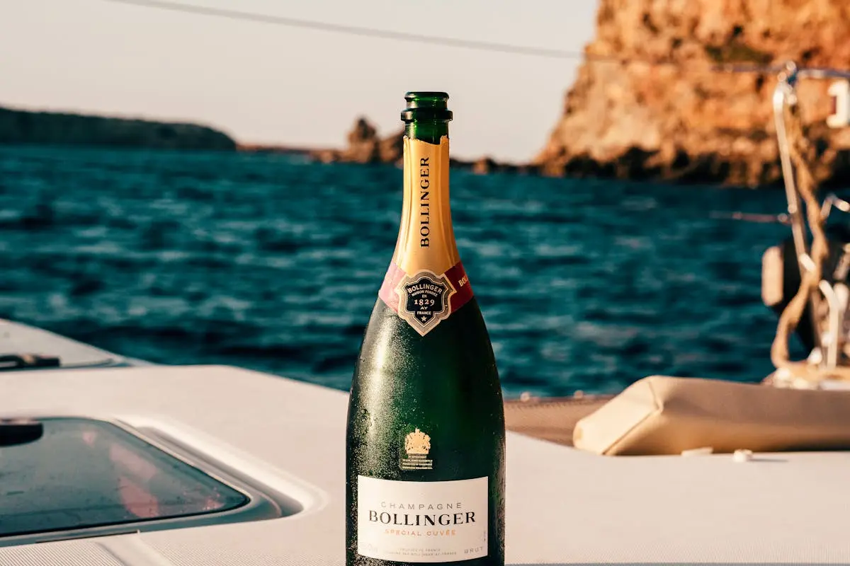Bollinger champagne bottle on a yacht with Ibiza’s ocean view, perfect for celebrations.