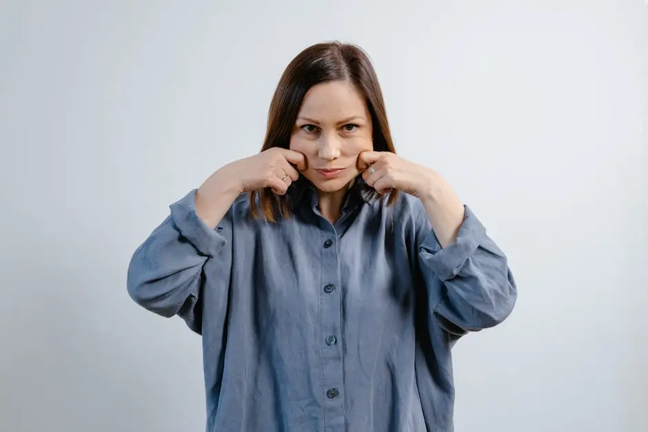 A woman demonstrates facial exercises, promoting wellness and skin care routines.
