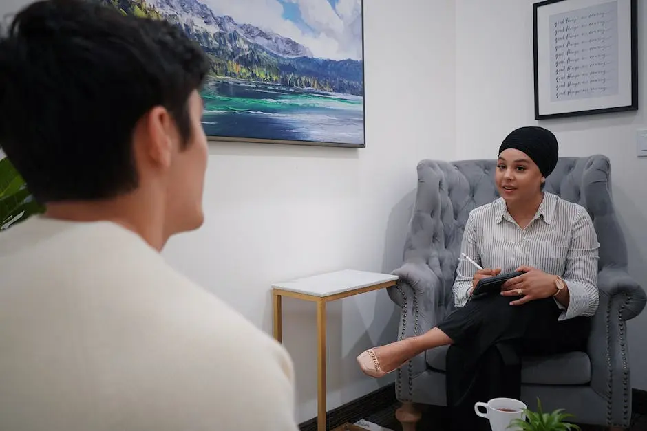 A therapist conducts a one-on-one session with a client in a comfortable office environment.