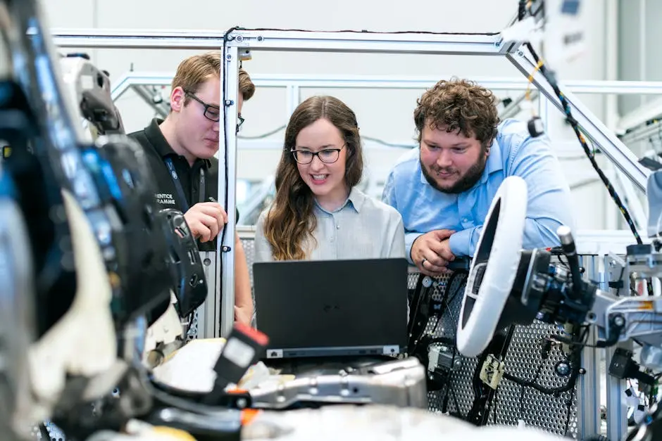 Engineers collaborating on a car project in a modern automotive workshop using advanced technology.