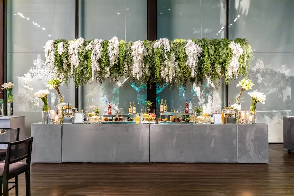 Stylish event bar with hanging greenery and floral arrangements, perfect for a sophisticated setting.