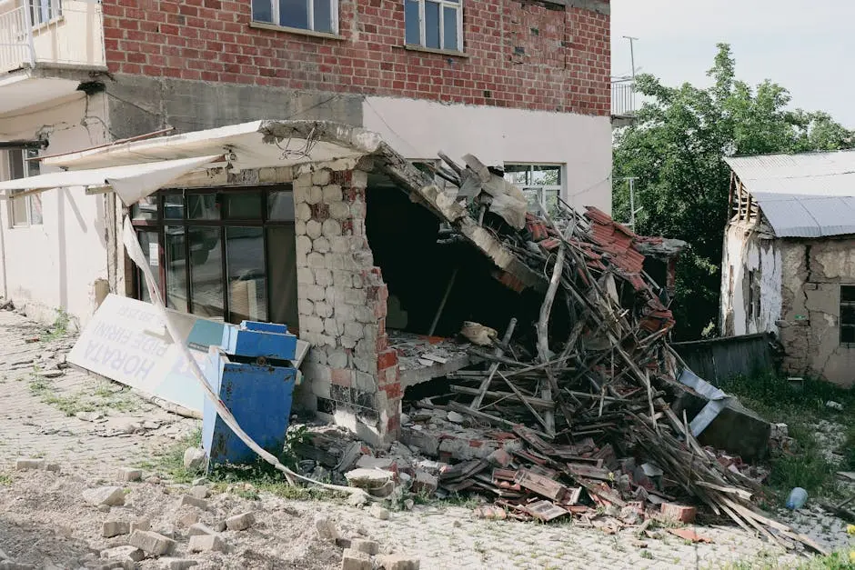 A heavily damaged building exterior, showing structural collapse post-earthquake.