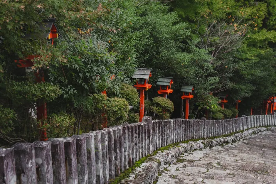 Serene stone pathway lined with traditional Japanese lanterns in lush greenery.