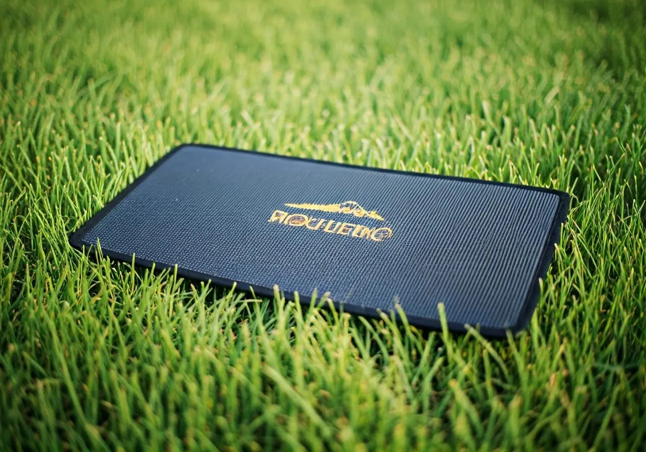 A grounding mat placed outdoors on lush green grass. 35mm stock photo