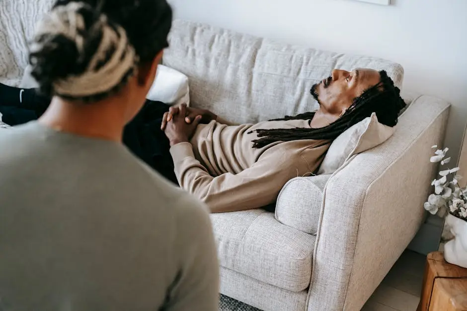 A therapy session with a patient lying on a couch, engaging with the therapist.