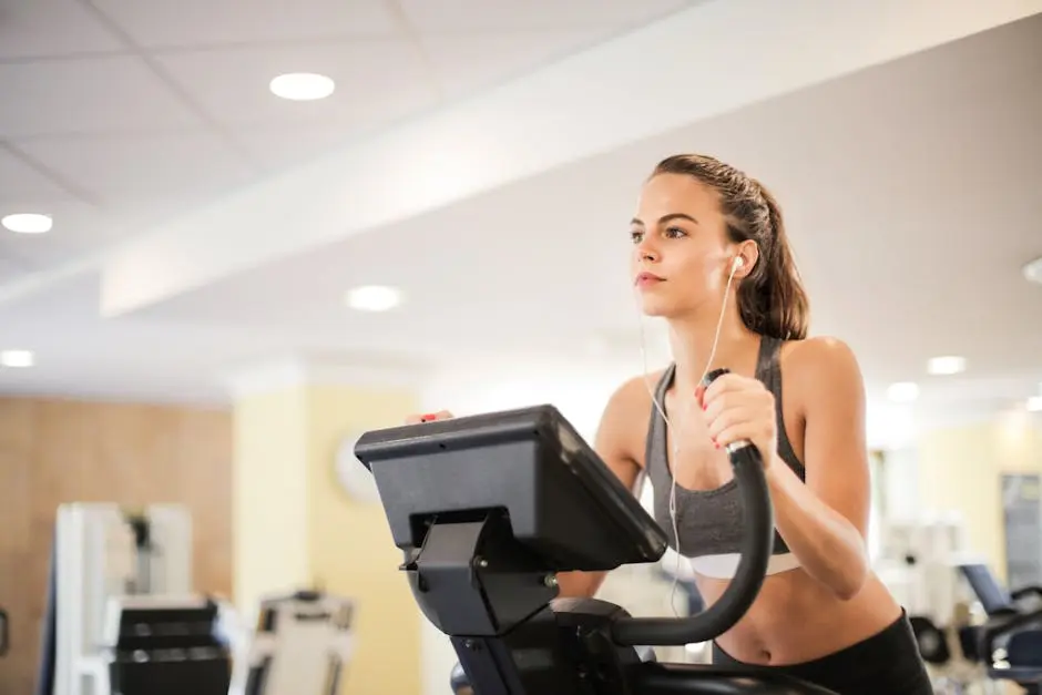 Woman in a gym focused on cardio exercise using elliptical machine. Healthy lifestyle and fitness concept.