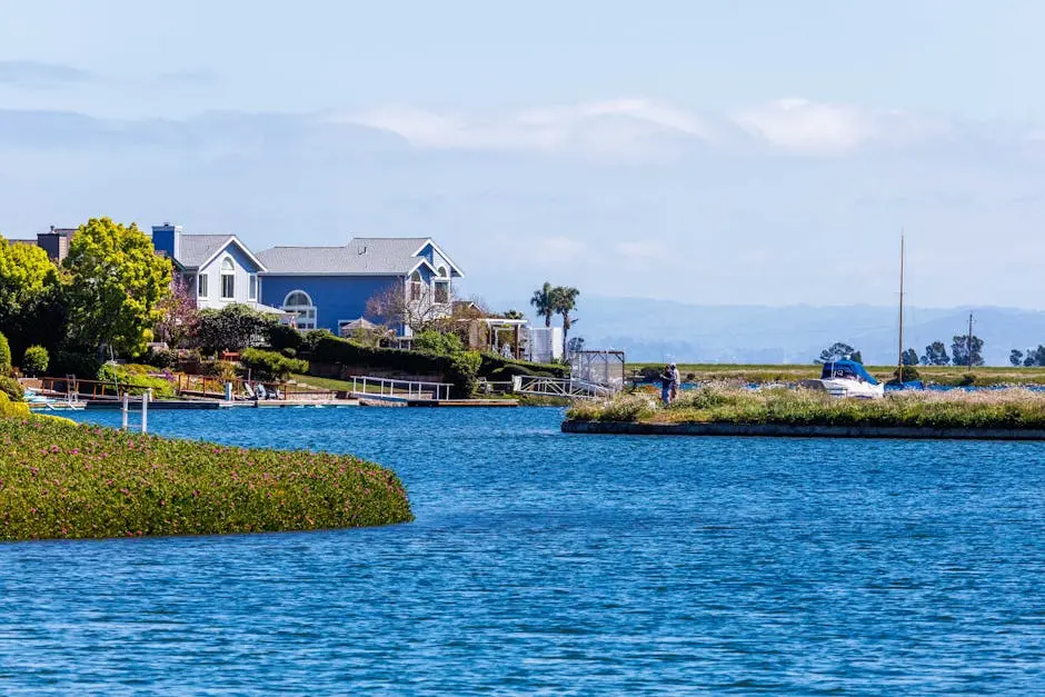 Charming lakeside house with a beautiful waterfront view, surrounded by greenery and serene water.