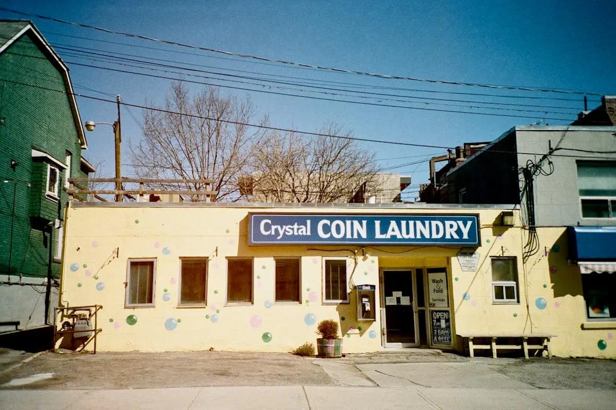 Colorful facade of crystal coin laundry in toronto on a sunny day.