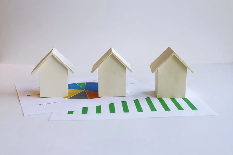 Wooden model houses on graphs depict real estate market analysis and trends.