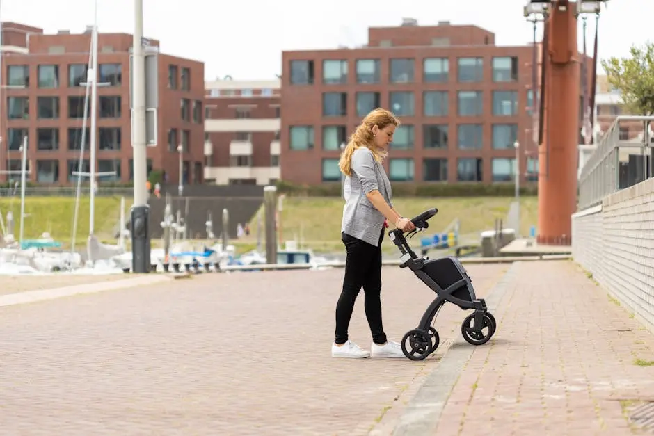 A woman with a modern walker strolls along a scenic waterfront, showcasing independence and mobility.