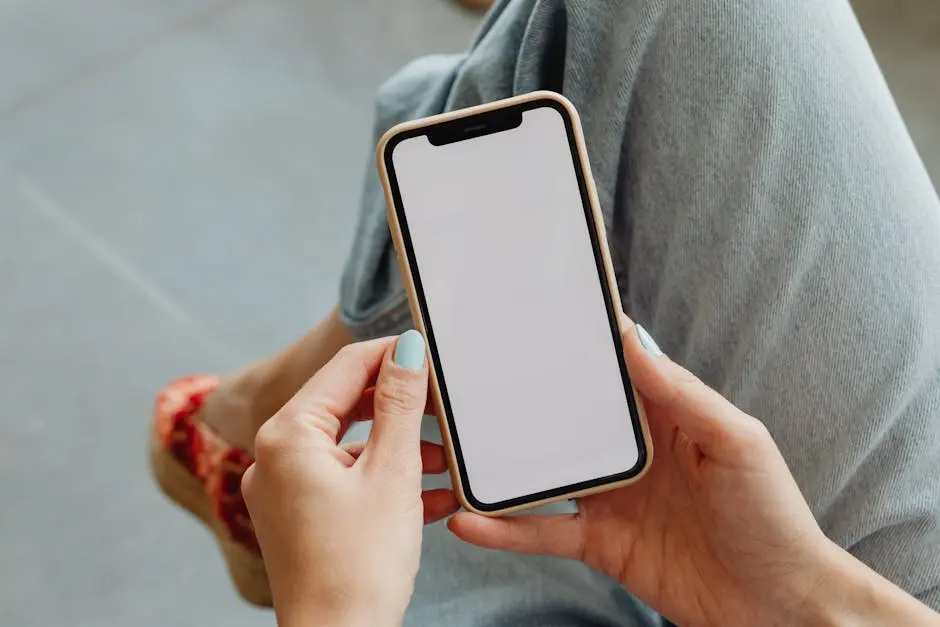 Woman holding smartphone with blank screen, perfect for app mockups or design presentations.